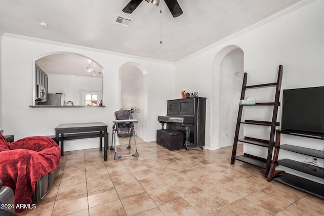 living room with ceiling fan and crown molding