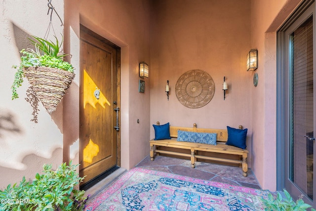 doorway to property with stucco siding