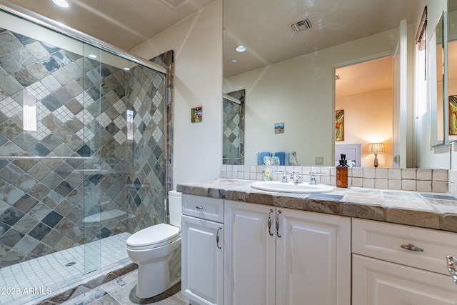 full bath with toilet, a shower stall, visible vents, and vanity