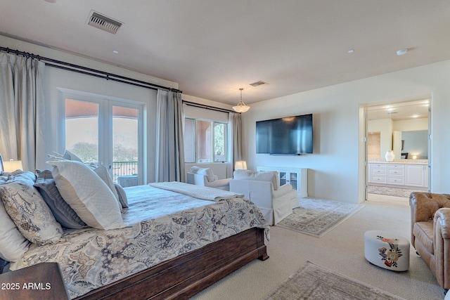 carpeted bedroom featuring visible vents, french doors, and ensuite bathroom