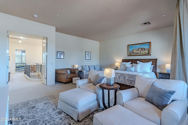 carpeted bedroom featuring visible vents