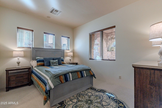 bedroom with visible vents and light colored carpet