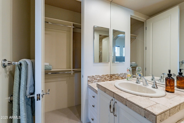 bathroom featuring vanity and decorative backsplash