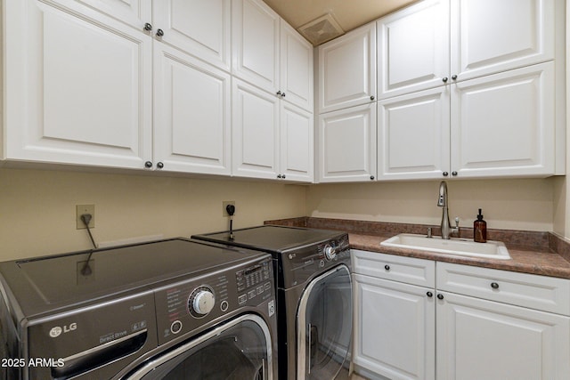 laundry room with cabinet space, a sink, and separate washer and dryer