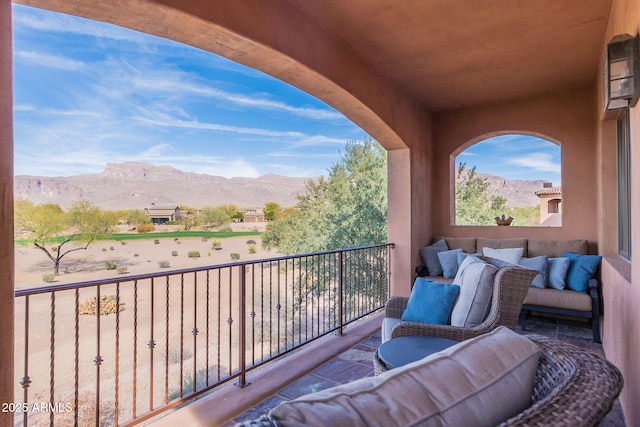 balcony with a mountain view and an outdoor hangout area