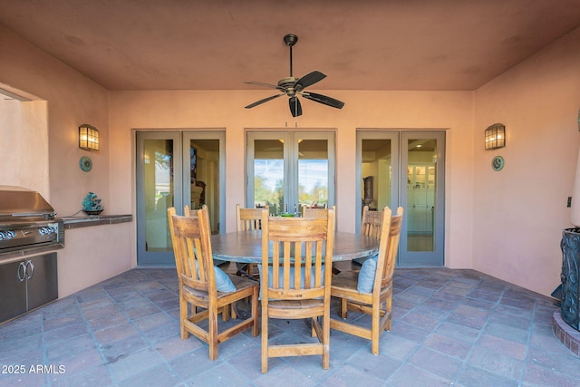 view of patio / terrace with outdoor dining area, grilling area, exterior kitchen, and french doors