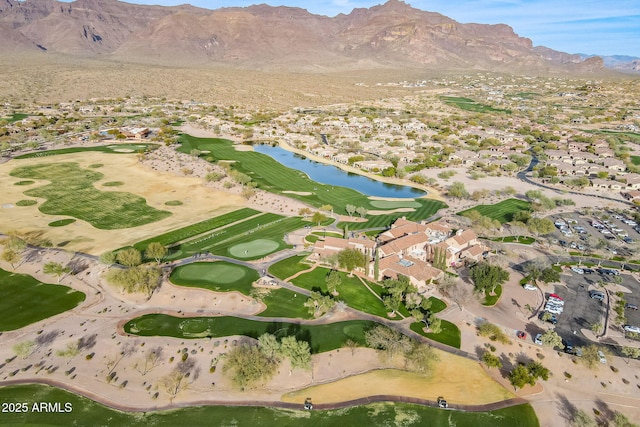 aerial view with view of golf course and a water and mountain view