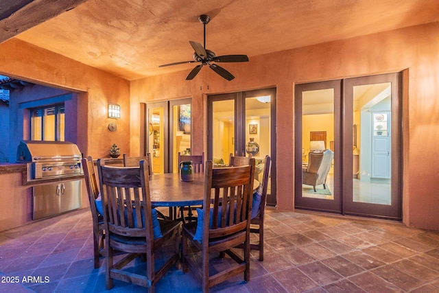 dining space featuring ceiling fan and french doors