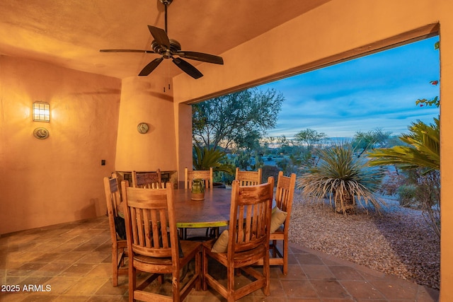 view of patio featuring outdoor dining area and a ceiling fan