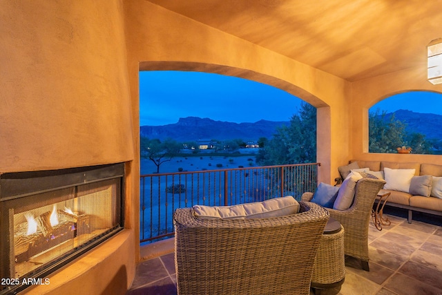 balcony with an outdoor living space and a mountain view