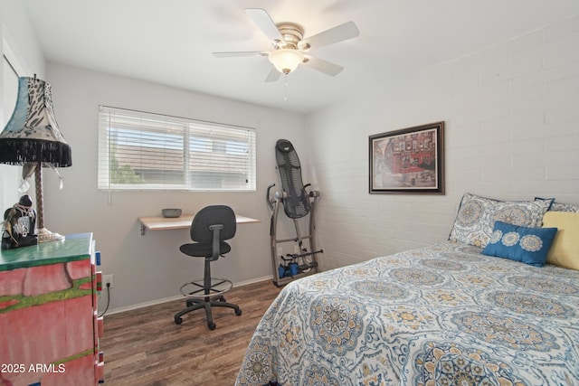 bedroom featuring a ceiling fan, baseboards, and wood finished floors