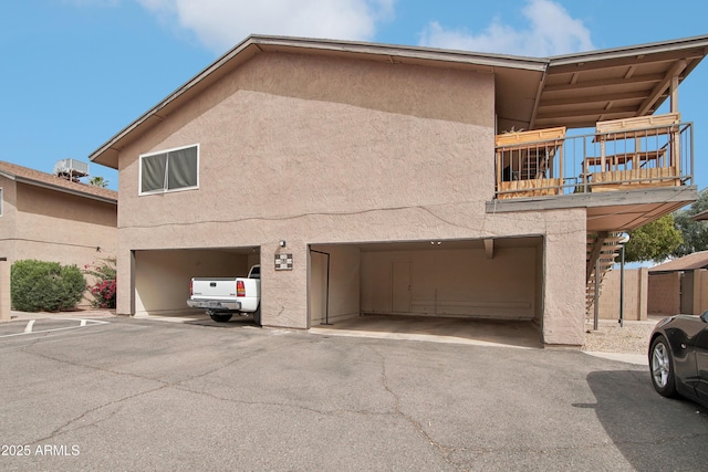 view of front of property with a balcony and stucco siding