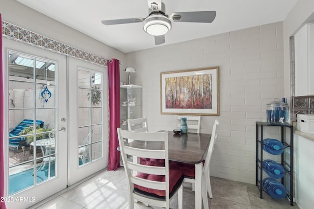 dining area with a ceiling fan and french doors