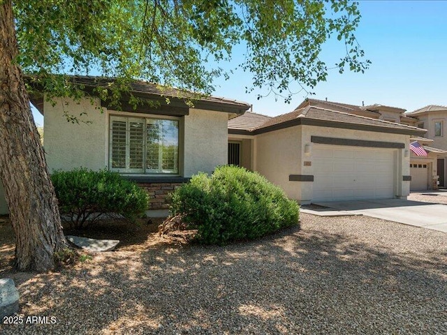 271 W Roadrunner Dr, Chandler, AZ 85286 - view of front of property featuring concrete driveway, an attached garage, and stucco siding