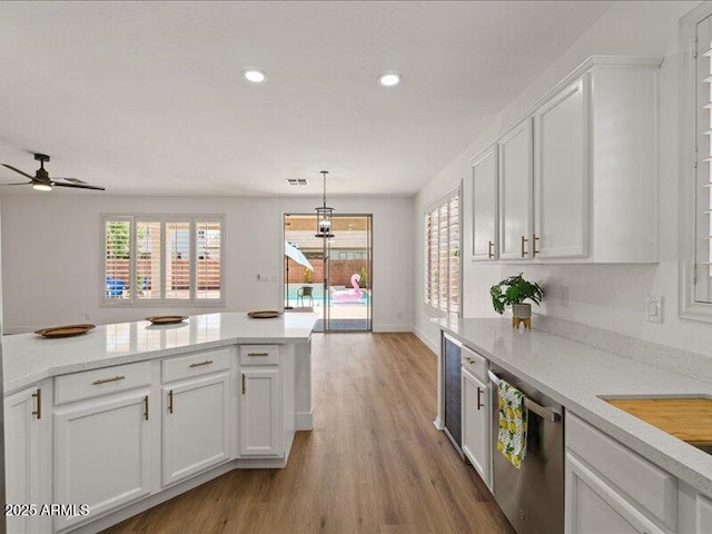 271 W Roadrunner Dr, Chandler, AZ 85286 - kitchen featuring stainless steel dishwasher, light countertops, white cabinetry, and wood finished floors