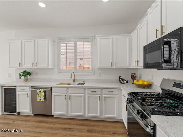 271 W Roadrunner Dr, Chandler, AZ 85286 - kitchen featuring white cabinets, appliances with stainless steel finishes, a sink, light countertops, and wine cooler