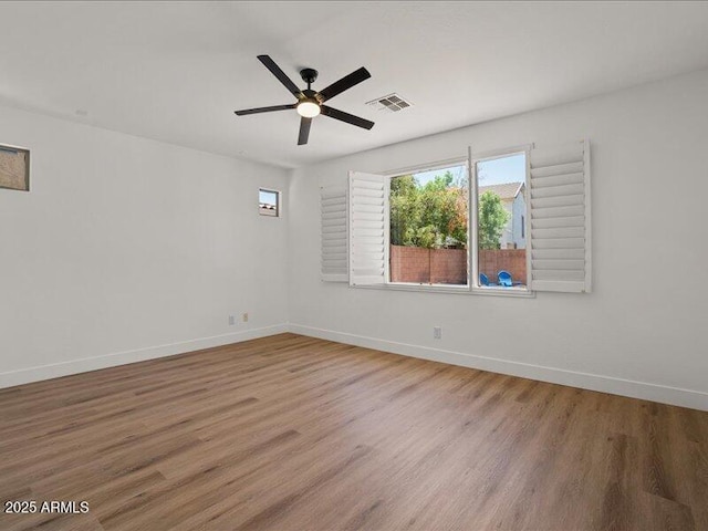 271 W Roadrunner Dr, Chandler, AZ 85286 - empty room with baseboards, a ceiling fan, wood finished floors, and visible vents