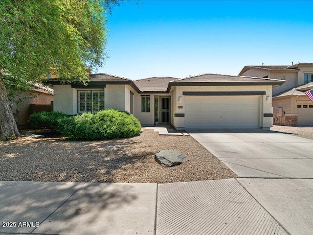 271 W Roadrunner Dr, Chandler, AZ 85286 - view of front of house with an attached garage, driveway, and stucco siding