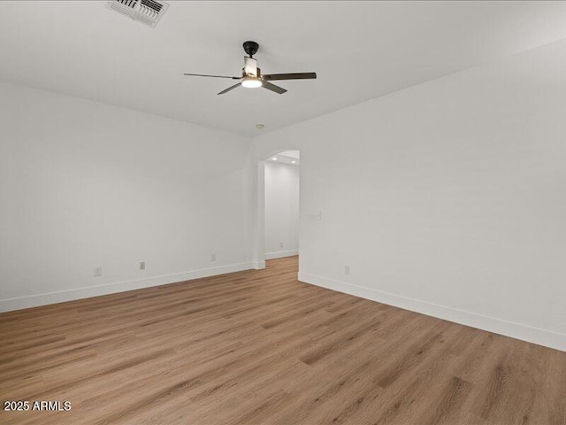 271 W Roadrunner Dr, Chandler, AZ 85286 - empty room featuring a ceiling fan, visible vents, arched walkways, baseboards, and light wood-style floors