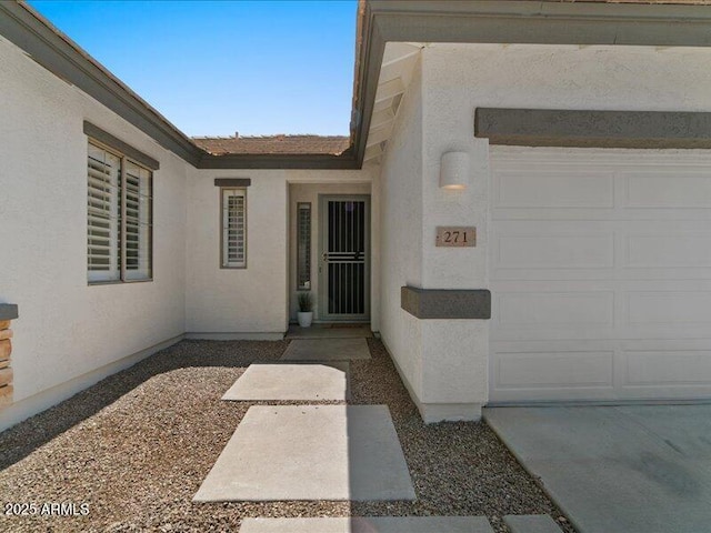 271 W Roadrunner Dr, Chandler, AZ 85286 - doorway to property with an attached garage and stucco siding