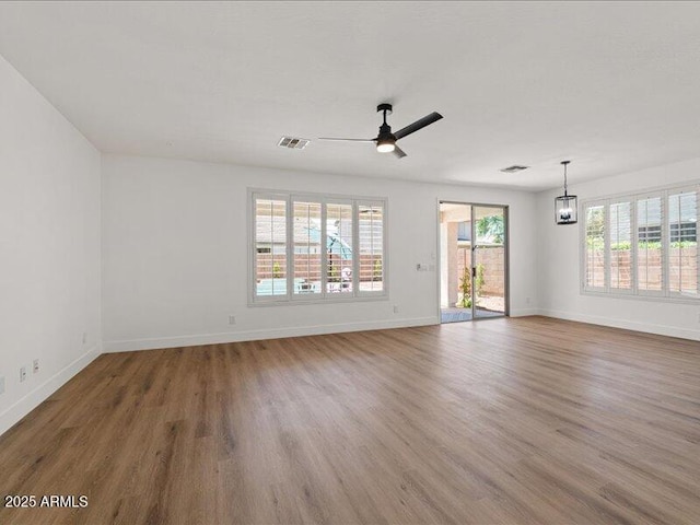 271 W Roadrunner Dr, Chandler, AZ 85286 - unfurnished living room featuring visible vents, a ceiling fan, baseboards, and wood finished floors