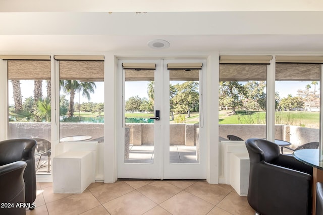 entryway featuring french doors and light tile patterned flooring