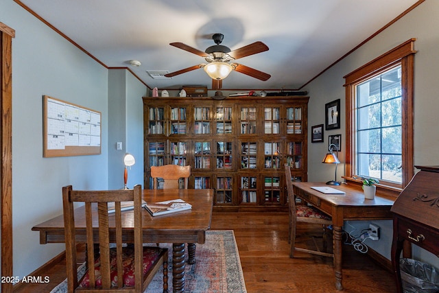 dining room featuring crown molding, a ceiling fan, wood finished floors, and visible vents