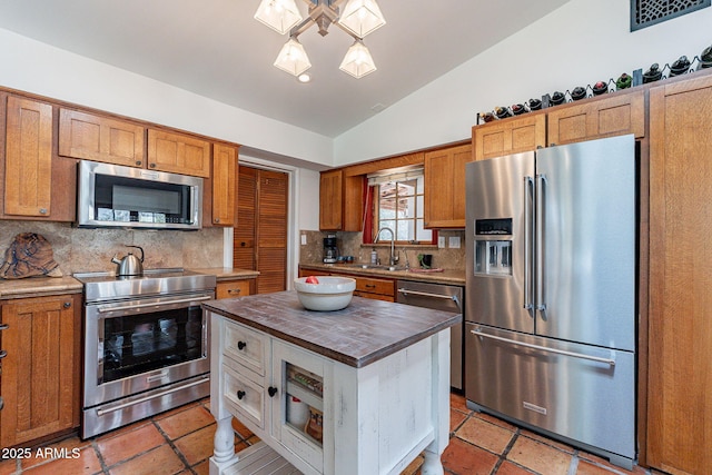 kitchen with visible vents, lofted ceiling, wooden counters, tasteful backsplash, and appliances with stainless steel finishes