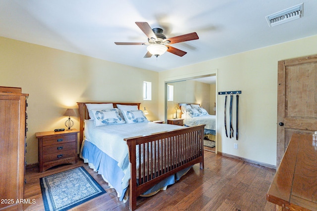 bedroom featuring ceiling fan, wood finished floors, and visible vents