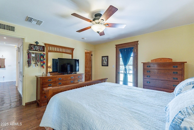 bedroom with a ceiling fan, baseboards, visible vents, and dark wood finished floors