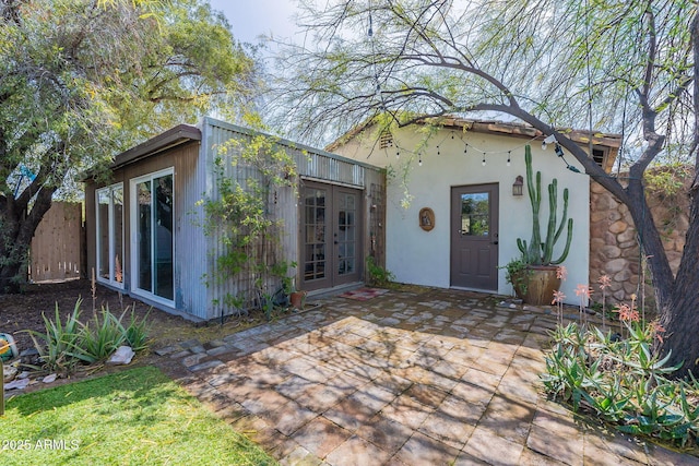 exterior space featuring a patio, french doors, and stucco siding