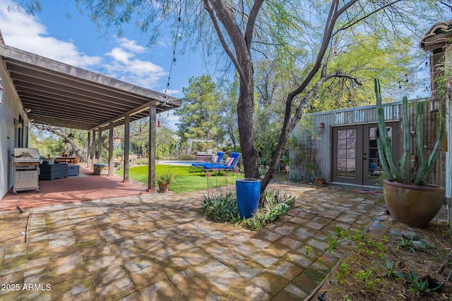 view of patio featuring outdoor lounge area, grilling area, and french doors
