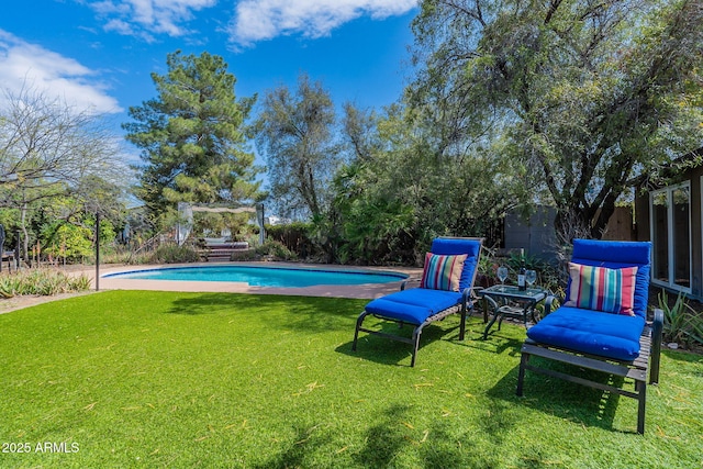 outdoor pool with a fenced backyard and a yard