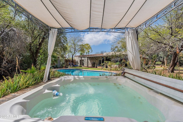 view of pool with a fenced in pool and an outdoor hot tub