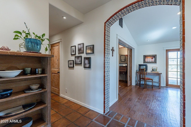 hallway featuring baseboards, recessed lighting, and vaulted ceiling