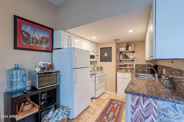 kitchen with white cabinetry, sink, light tile patterned floors, and white appliances