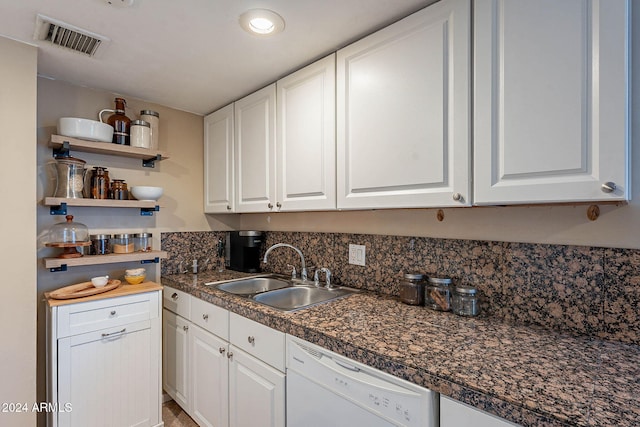 kitchen featuring white dishwasher, white cabinetry, and sink