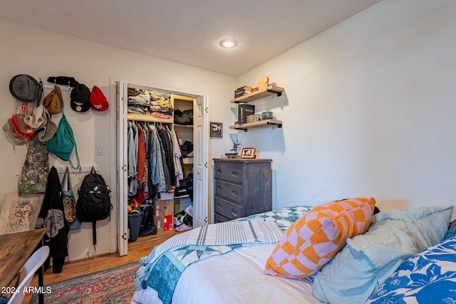 bedroom with hardwood / wood-style floors and a closet