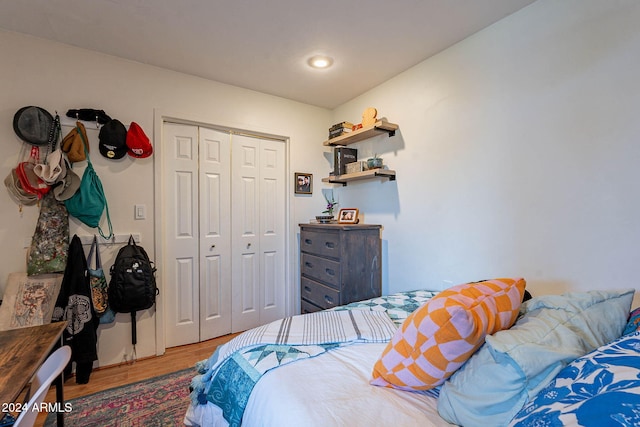 bedroom with a closet and hardwood / wood-style flooring