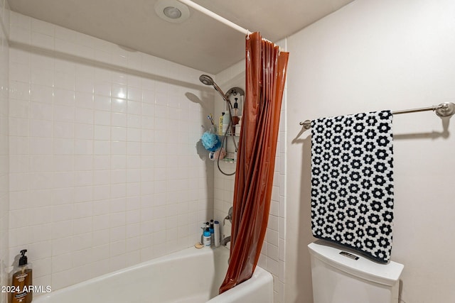 bathroom with shower / tub combo and toilet