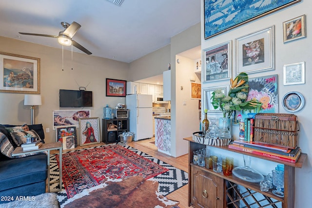 living room featuring light wood-type flooring and ceiling fan