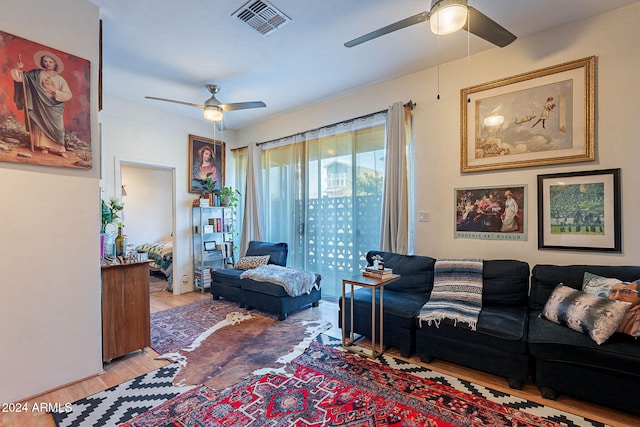 living room featuring ceiling fan and light wood-type flooring