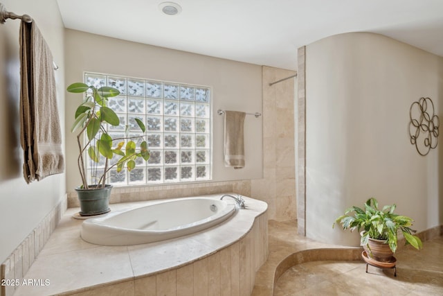 bathroom with tiled tub