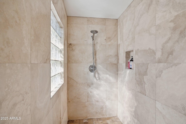 bathroom with a tile shower