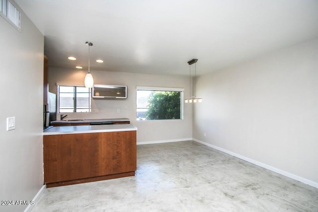 1630 E Georgia Ave Unit 208, Phoenix, AZ 85016 - kitchen featuring freestanding refrigerator, light countertops, finished concrete flooring, recessed lighting, and decorative light fixtures