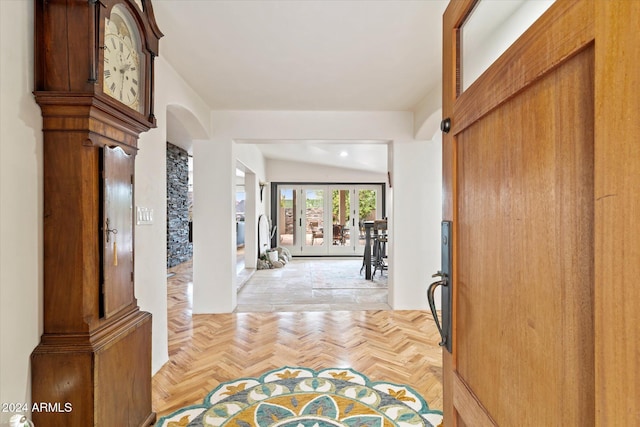 foyer entrance with french doors and light parquet floors