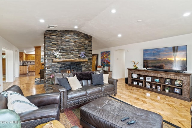 living room with a stone fireplace, lofted ceiling, and parquet flooring