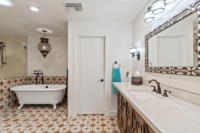 bathroom with plus walk in shower, vanity, and tile walls