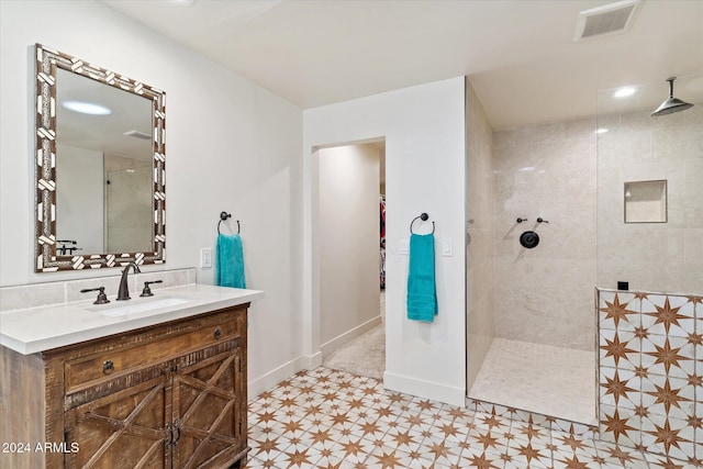 bathroom with vanity and tiled shower