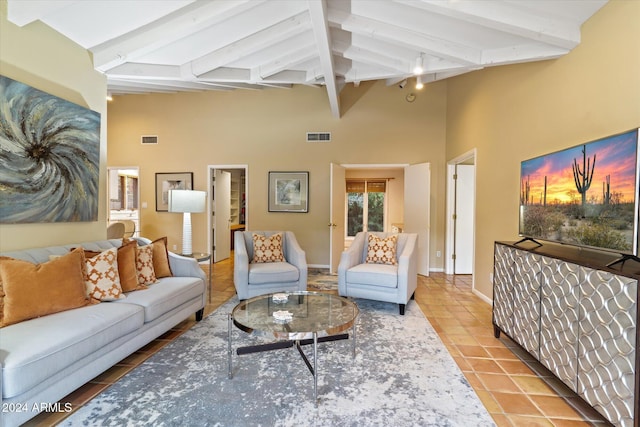 living room featuring beam ceiling, tile patterned flooring, and high vaulted ceiling